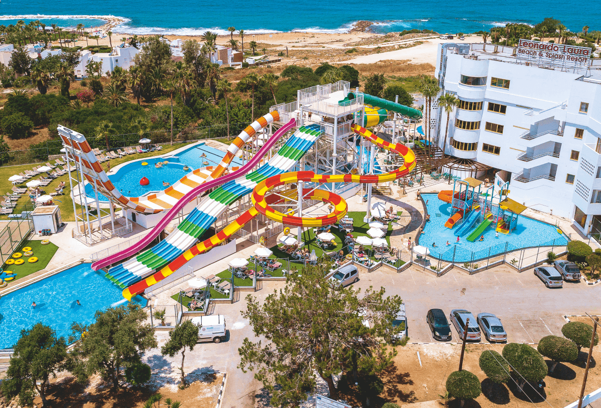 A photo of the slides and pools at Laura Beach and Splash Resort beside the beach and ocean.