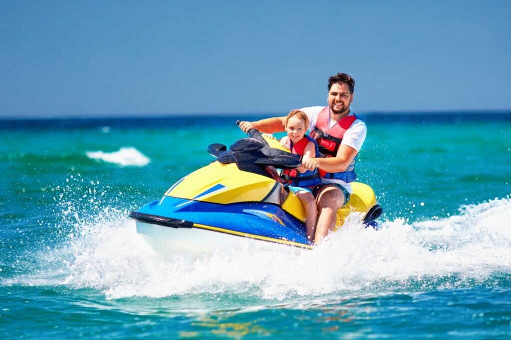 happy, excited family, father and child having fun on jet ski