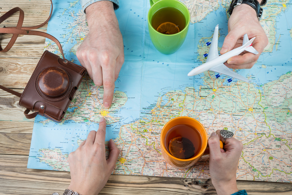 Couple of friends looking over a map to decide on plans for a holiday